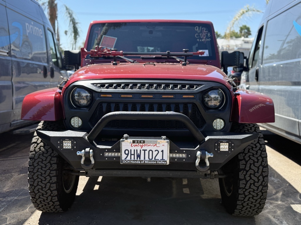 Used 2012 Red Jeep Unlimited Sahara image 1