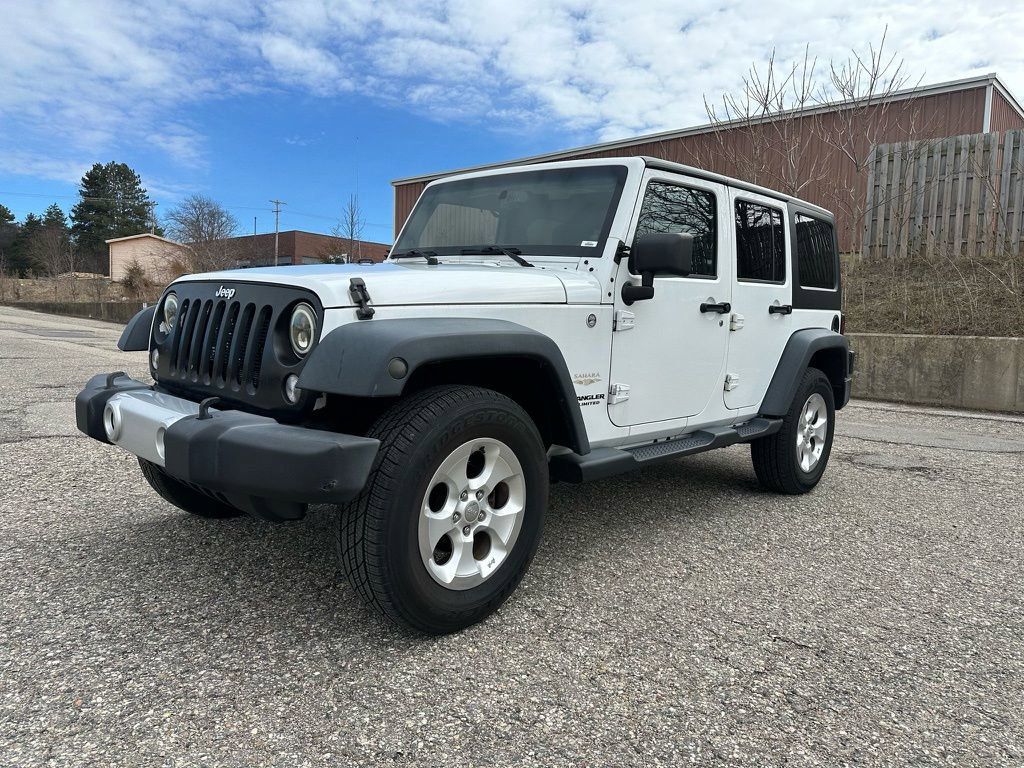 Used 2014 Jeep Wrangler Unlimited Sahara with VIN 1C4BJWEG4EL106570 for sale in Grandville, MI